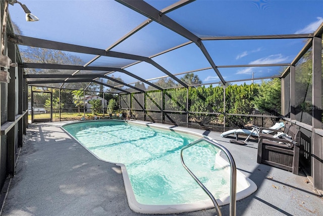 view of pool featuring glass enclosure and a patio