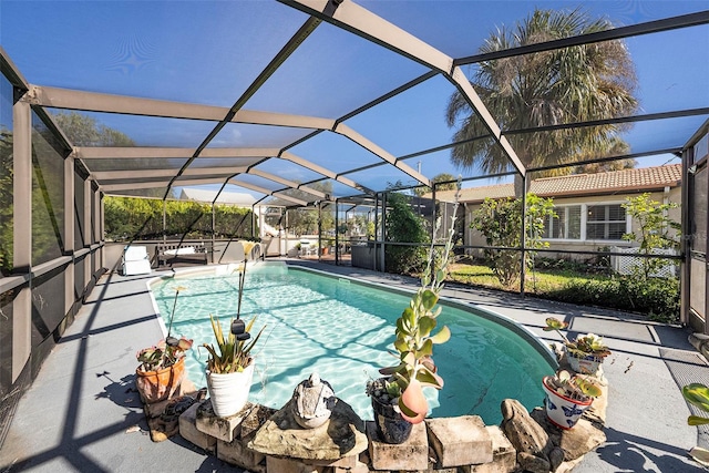 view of swimming pool with a lanai and a patio