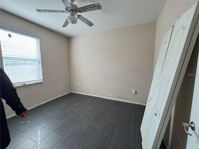 unfurnished room with ceiling fan and dark hardwood / wood-style floors