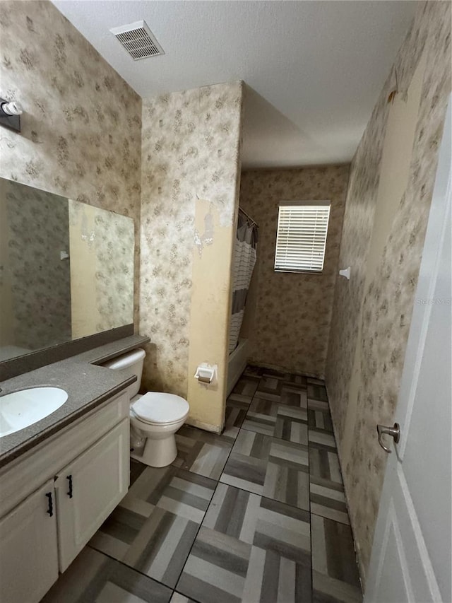 bathroom with vanity, toilet, and curtained shower