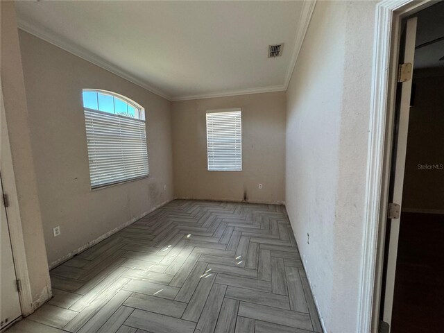 spare room featuring light parquet floors and ornamental molding