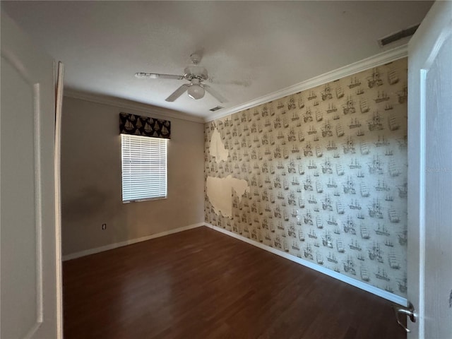 empty room featuring dark hardwood / wood-style floors, ceiling fan, and ornamental molding