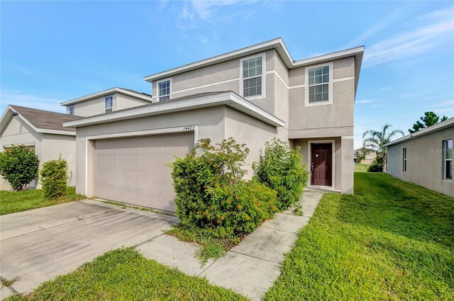 view of front of home featuring a garage and a front yard