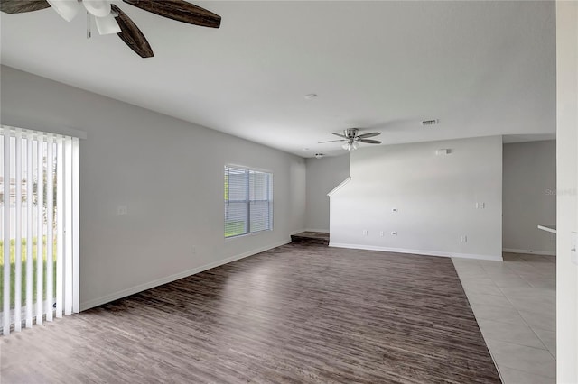 unfurnished living room featuring ceiling fan and light wood-type flooring