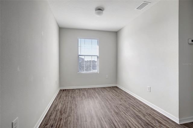 empty room featuring dark hardwood / wood-style flooring