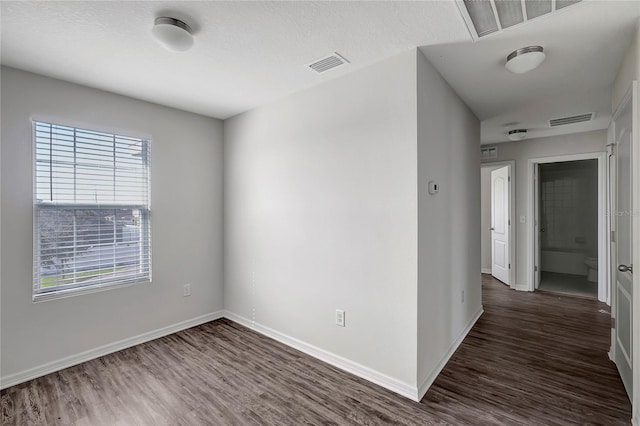 spare room with dark hardwood / wood-style flooring