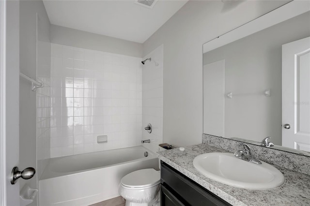 full bathroom featuring vanity, toilet, and tiled shower / bath