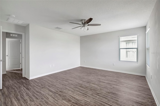 unfurnished room featuring ceiling fan, dark wood-type flooring, and a textured ceiling