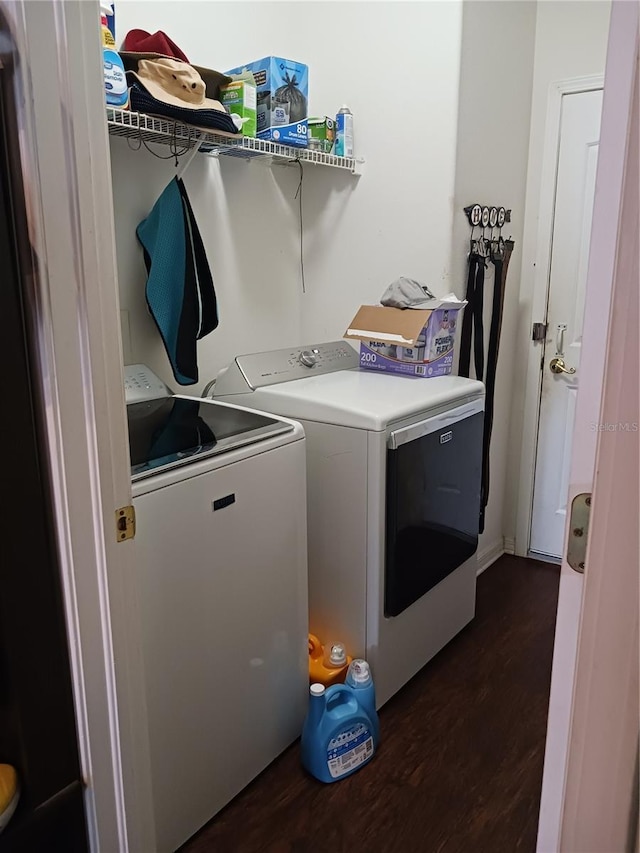 clothes washing area with separate washer and dryer and dark hardwood / wood-style floors