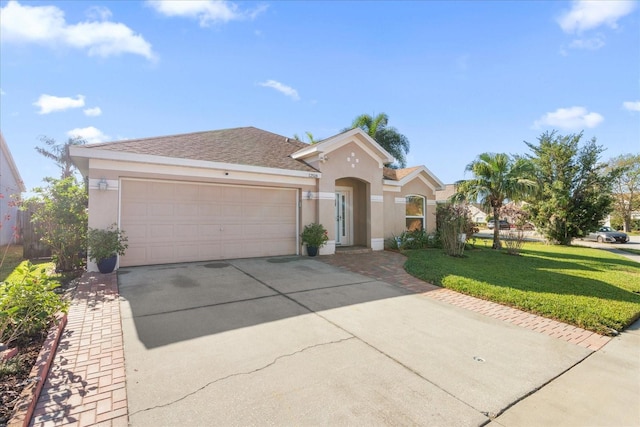 view of front of property featuring a front yard and a garage