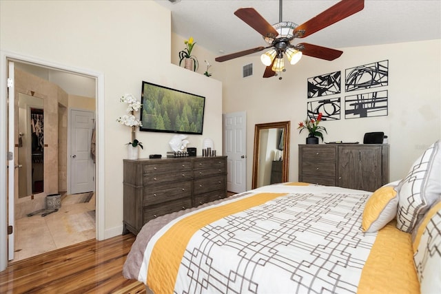 bedroom with lofted ceiling, light hardwood / wood-style flooring, and ceiling fan