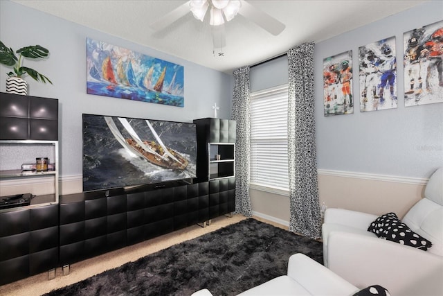 carpeted living room with ceiling fan