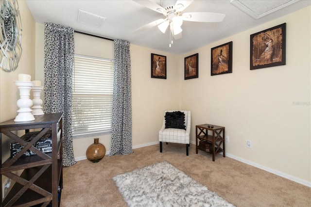 sitting room with a healthy amount of sunlight, light carpet, a textured ceiling, and ceiling fan