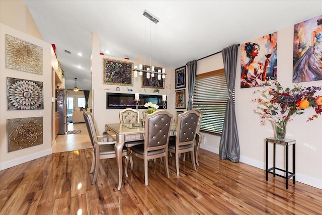 dining area with lofted ceiling and hardwood / wood-style floors