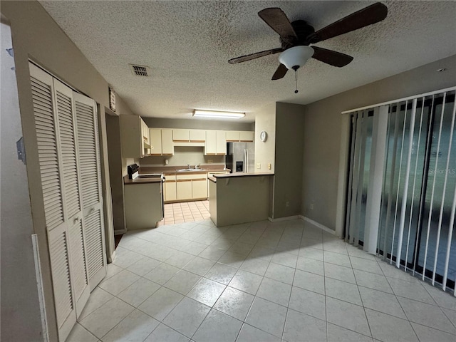 kitchen with stainless steel fridge with ice dispenser, a textured ceiling, and light tile patterned floors