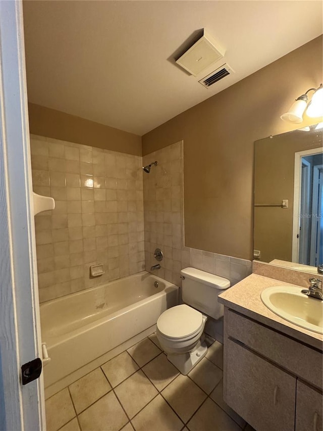 full bathroom with tile patterned floors, vanity, toilet, and tiled shower / bath