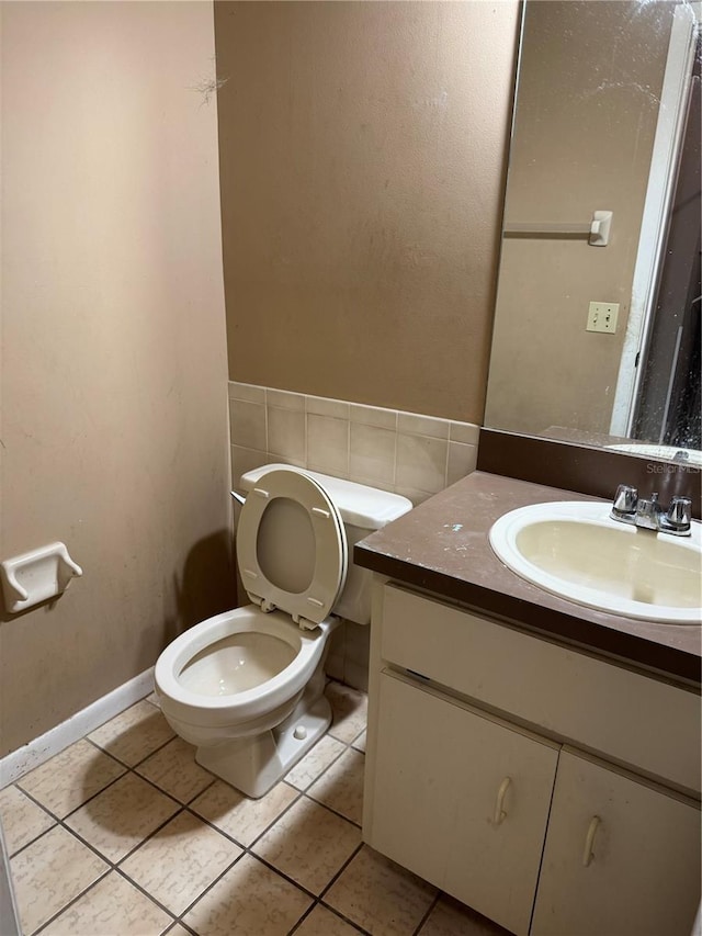 bathroom with tile patterned flooring, vanity, and toilet