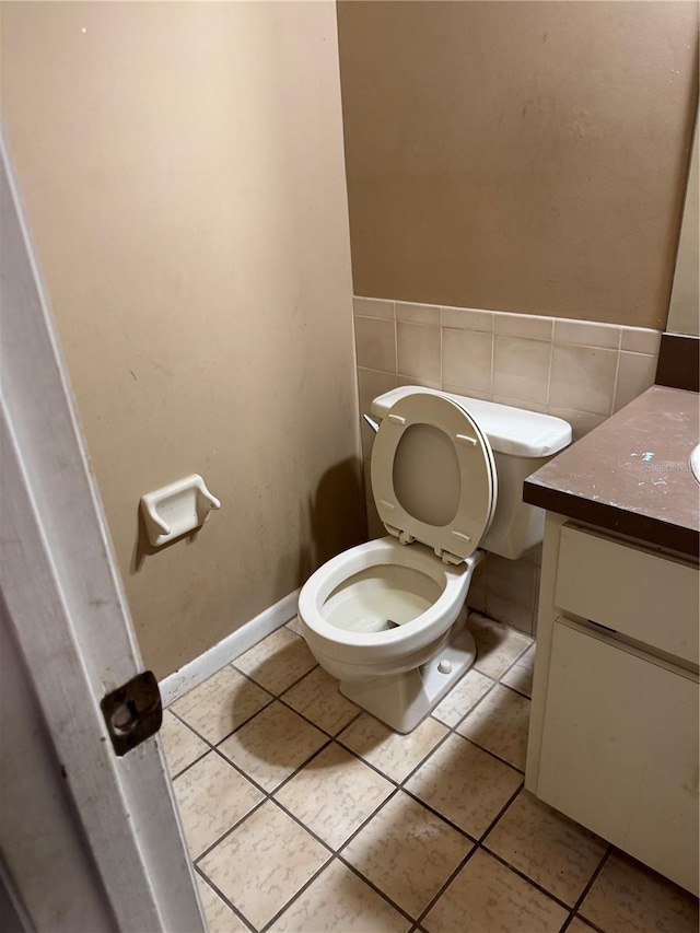 bathroom featuring tile patterned flooring, vanity, and toilet