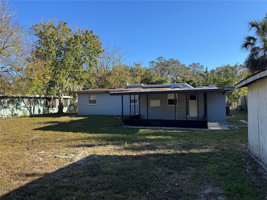 back of house with a yard