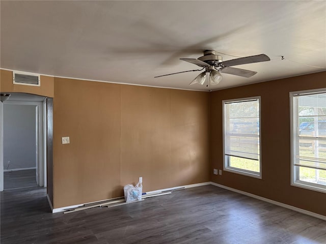 spare room with dark hardwood / wood-style floors and ceiling fan