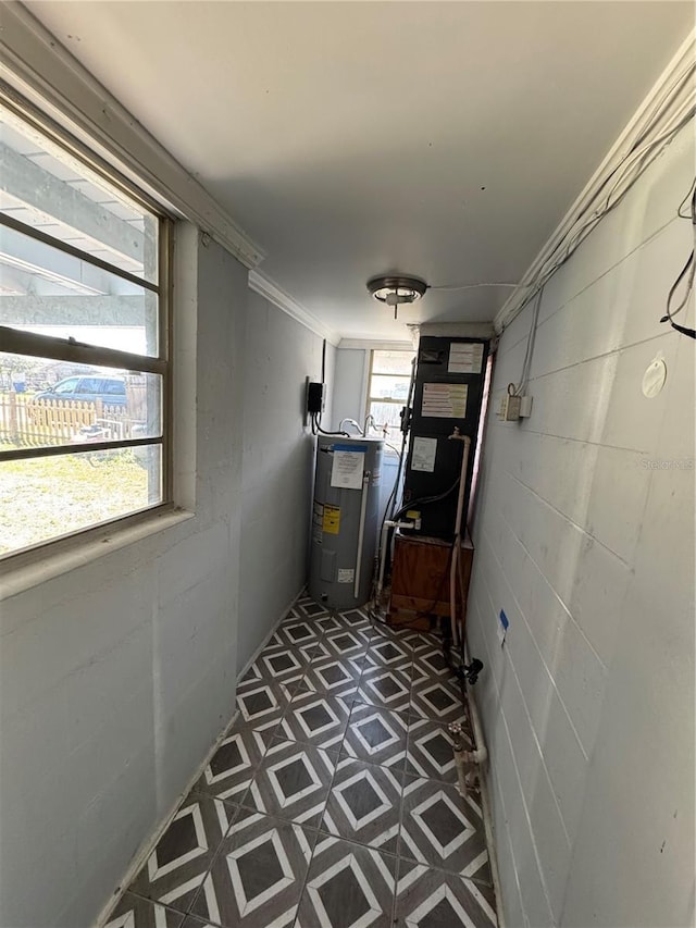 corridor featuring crown molding and electric water heater