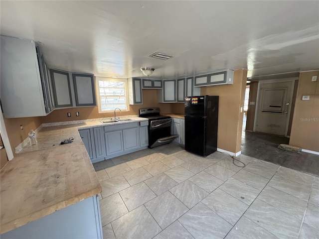 kitchen with sink, range with electric stovetop, and black fridge