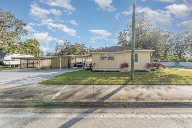 view of front facade with a front lawn and a carport