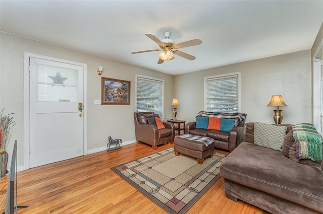 living room featuring wood-type flooring and ceiling fan