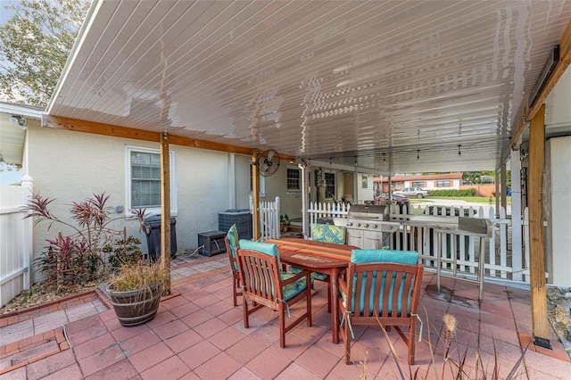 view of patio with a grill and central AC unit