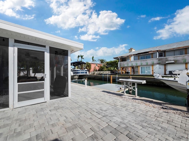 view of patio / terrace featuring a dock and a water view