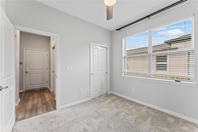 unfurnished bedroom featuring light wood-type flooring, a closet, and ceiling fan