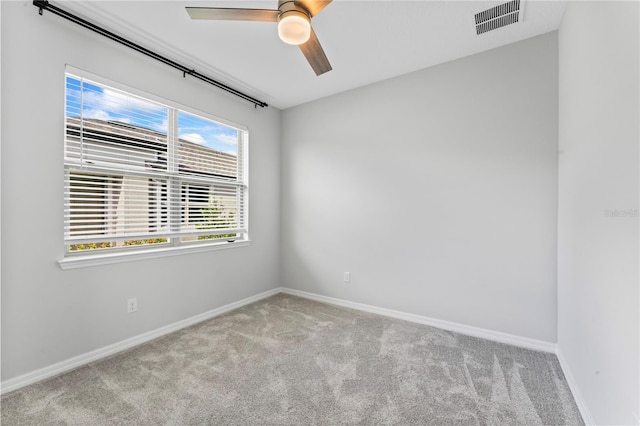 carpeted empty room featuring ceiling fan