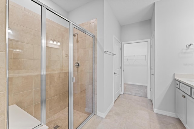 bathroom featuring tile patterned floors, vanity, and walk in shower