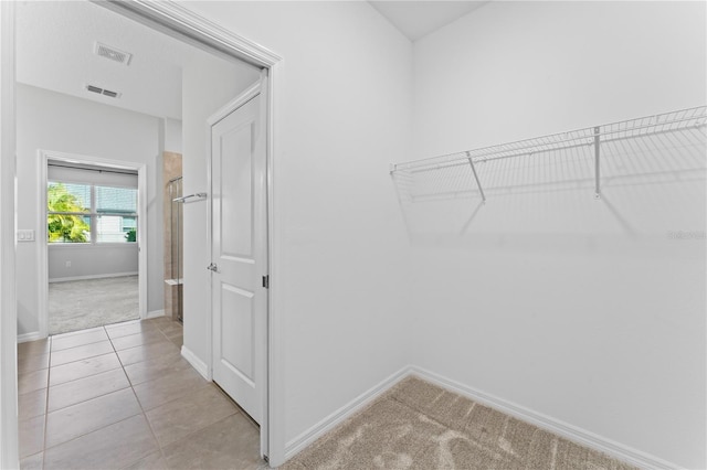 walk in closet featuring light tile patterned floors