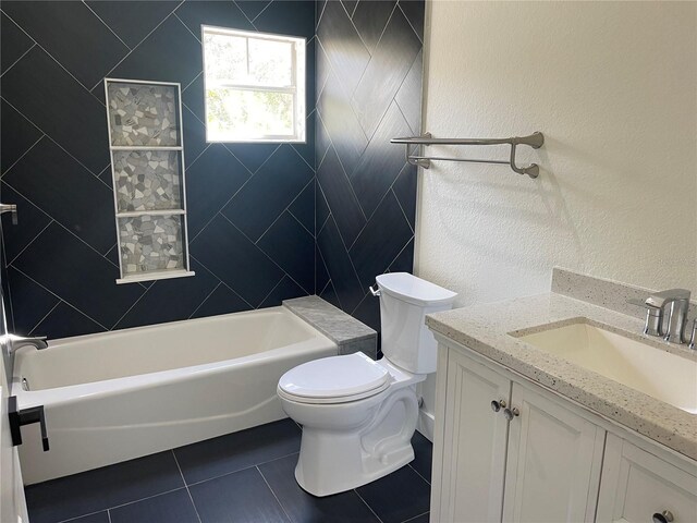 bathroom with toilet, vanity, and tile patterned floors