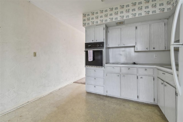 kitchen featuring white cabinetry, oven, and stainless steel gas cooktop