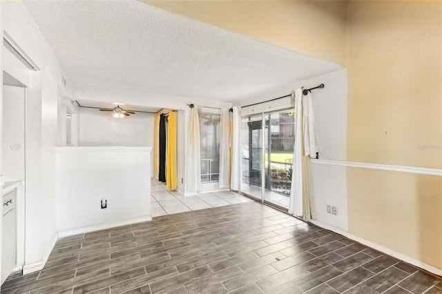 spare room featuring ceiling fan, hardwood / wood-style floors, and a textured ceiling