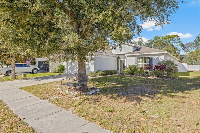 view of front of property with a garage and a front lawn