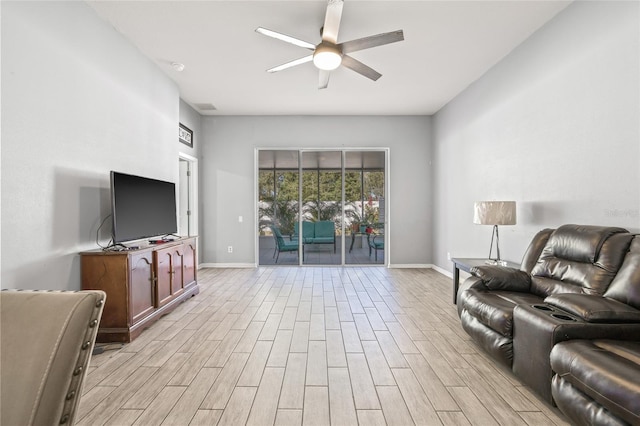 living room with light wood-type flooring and ceiling fan