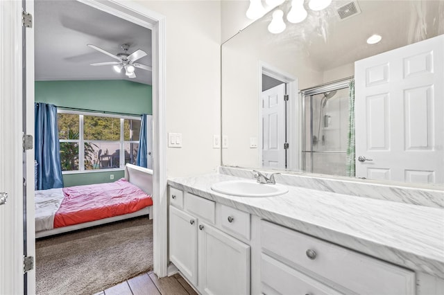 bathroom featuring an enclosed shower, vanity, vaulted ceiling, ceiling fan, and wood-type flooring