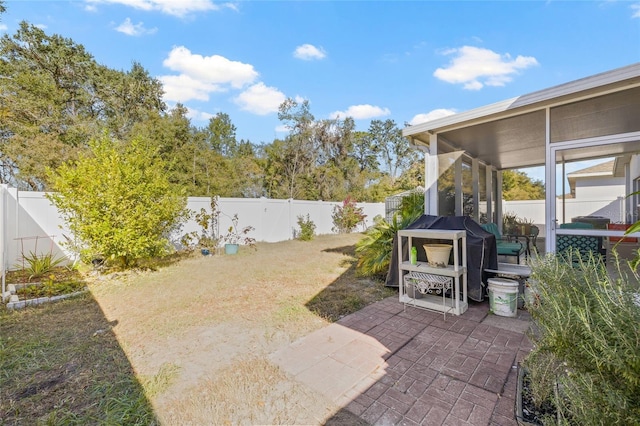 view of patio featuring a sunroom