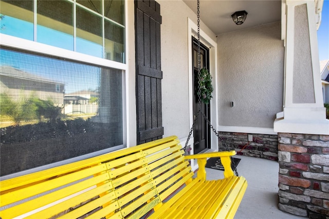 view of exterior entry with covered porch