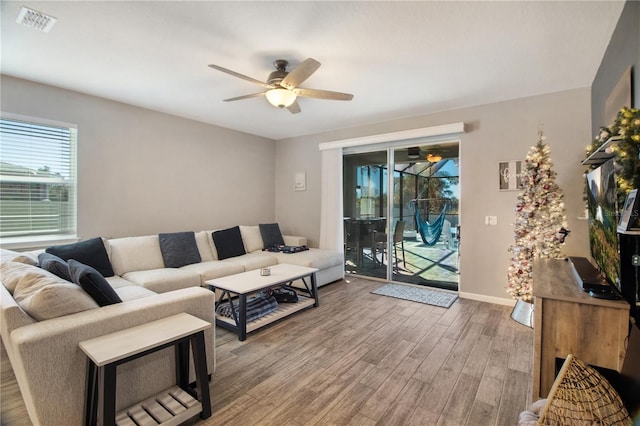 living room with hardwood / wood-style flooring and ceiling fan