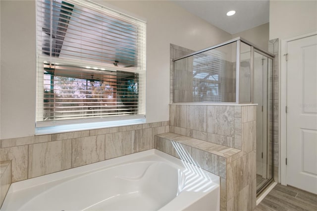 bathroom with wood-type flooring and independent shower and bath