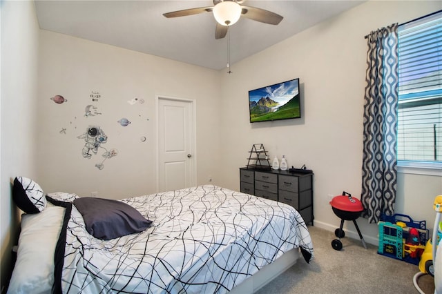 carpeted bedroom with multiple windows and ceiling fan