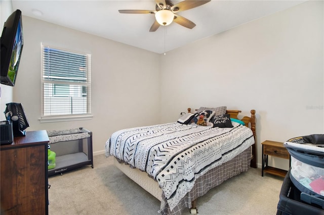 bedroom with ceiling fan and light carpet