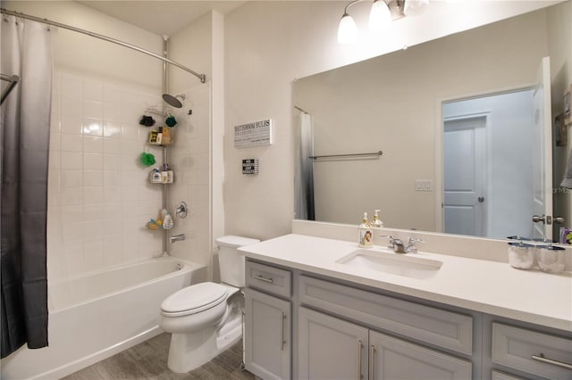 full bathroom with hardwood / wood-style floors, vanity, toilet, and shower / bathtub combination with curtain