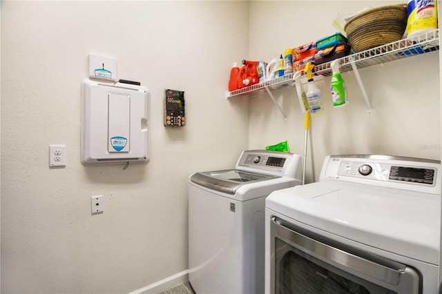 washroom with washing machine and clothes dryer