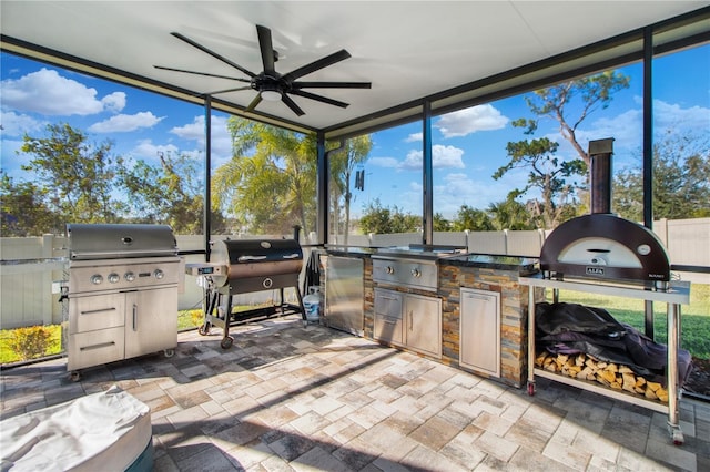 sunroom / solarium with ceiling fan and a healthy amount of sunlight