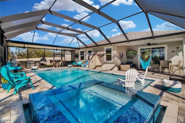 view of pool with a lanai, a patio area, and ceiling fan